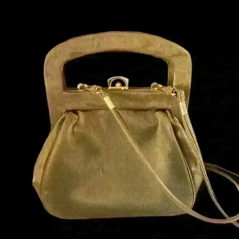 Gold Sateen ladies bag. Snap closure long removable strap.